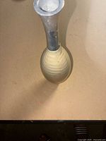 Full view of vase showing silver neck and pearl white body