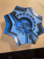 Top view showing star shape and blue glaze with black geometric decoration