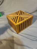 Top angle of wood marquetry box showing chevron lid pattern and striped sides