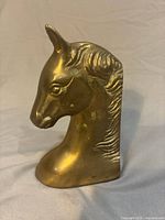 Front left view of brass horse head bookend showing overall form