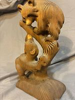 Front view of wood sculpture showing both bears