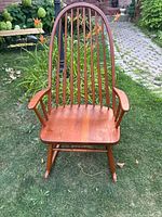 Front view of oak Windsor rocking chair showing full spindle back and rocker base