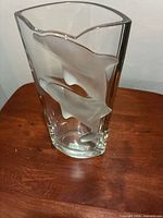 front view of rectangular crystal vase showing two frosted dolphins