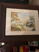 Full view of framed watercolour painting in brown frame