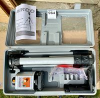 Open carry case showing rotary laser level, tripod, manual, hardware