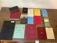 Full layout of all manuals, books, binders and notebooks on table