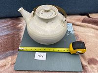 Full view of teapot showing size reference tape at about 8 in