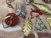 mixed ornaments including sequin ball, gold drop, metal tree, painted tree, foil rosettes