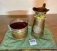 Overall view of pitcher and bucket on cloth