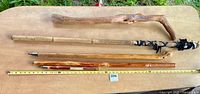 Overview of five walking sticks on table with measuring tape