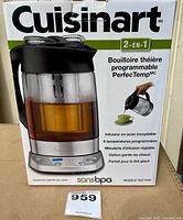 Front of retail box showing Cuisinart TEA-1000 tea steeper and kettle image and features list