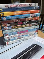 Stack of 10 DVDs showing titles