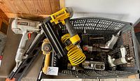 Overview of crate showing DeWalt nailer, air hose and assorted air tools