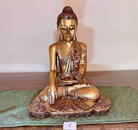 Front view of golden Buddha statue