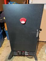 Front view of black propane smoker cabinet