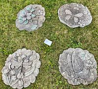 All four decorative stepping stones on grass