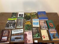 All fifteen books laid out on table, full lot overview