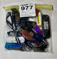 Front view of sealed bag showing assorted USB flash drives