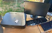 Canon printer, Acer monitor, Dell keyboard grouping on tabletop