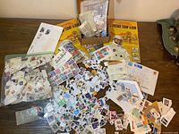 Overall layout showing two albums, box, bag and scattered stamps