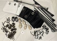 Overview of entire lot showing rods, finials, brackets, rings, white and black curtain panels