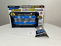 Front view of Monster Zapper box with instruction manual displayed