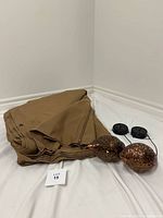 Folded tan canopy, two bronze-tone solar lights with solar panels