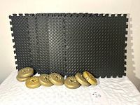 Group shot showing six mats and eight weight plates