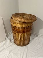 Hamper with lid resting on top showing overall shape and weave