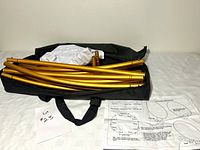 All components: gold tubes in black zip case, white water bag, instructions visible