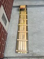 Full view of sled lying flat showing overall length and slat design