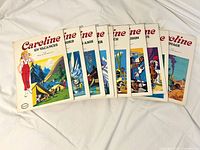 Eight Caroline books fanned out showing illustrated fronts