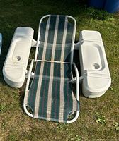 Top view of striped lounge chair flanked by two white plastic coolers