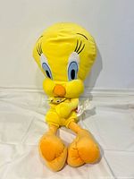 Front view of large Tweety Bird plush seated upright, tag visible