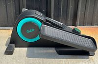 Side view of Cubii under-desk elliptical machine showing main body, pedal, and logo