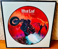 Framed picture disc vinyl record showing colorful artwork and title 'Meat Loaf Bat Out of Hell'.