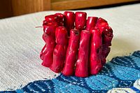 Side view of chunky red coral branch bracelet showing irregular branch shapes and natural coral texture.