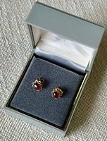 Photo of the earrings in open gray jewelry box with black velvet cushion