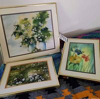 All three framed floral watercolor paintings displayed