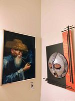 Overall view showing both the framed painting and mounted mask on adjacent walls