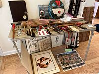 Wide shot of table showing assorted Hopi artifacts, prints, rug, vinyl record