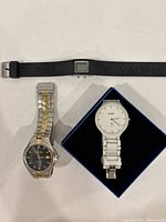 All three watches laid out: Rado, Elgin, digital