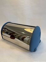 Bread box angled view showing blue end and stainless body