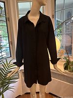 Front view of black blouse on mannequin