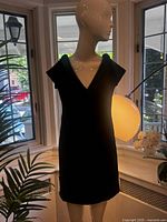 Front view of black Ozbek dress on mannequin