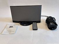 Front view of Bose SoundDock Series II with remote, power adapter, manual