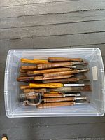 Bin of Craftsman wood turning tools and goggles