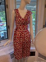 Full front view of sleeveless wrap dress on mannequin