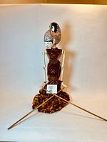 Full view of puppet with rods and costume