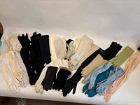 Full assortment of vintage gloves spread out to show variety of colours and lengths